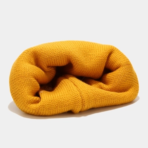 Detailed view of yellow ribbed knit beanie with thick yarn texture and warm design