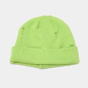 Close-up of neon green distressed knit beanie showing ripped textures and thick cuffs