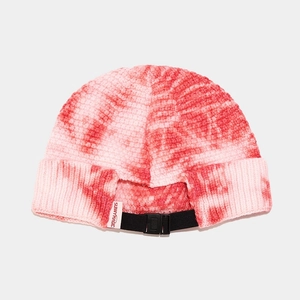 Detailed view of tie-dye knit beanie with adjustable black buckle strap and soft texture