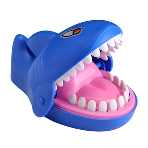 Close-up of blue shark biting toy with open mouth and pressable white teeth buttons