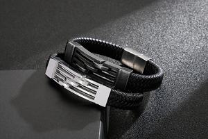 Detail of double-layer black braided leather bracelet with silver and gunmetal steel accents