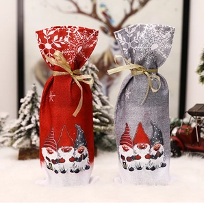 Detail of grey and red Christmas wine bags with gnome prints and gold ribbons