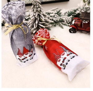 Detail of Christmas gnome wine gift bags in red and grey with festive snowflake patterns