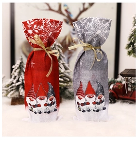 Close-up of Christmas wine bottle bags with gnome prints and snowflakes on plush mat
