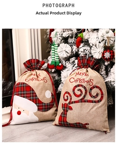 Detail of Christmas burlap gift bags with Santa and elk patterns and plaid trim