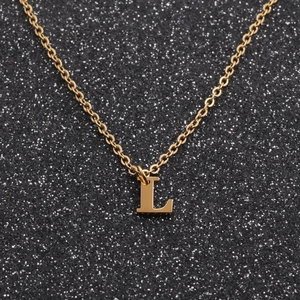 Detailed close-up of golden stainless steel chain necklace with letter L pendant