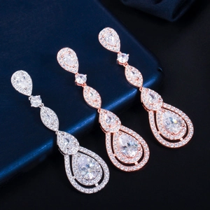 Detail of silver and rose gold drop earrings with AAA zircon inlay on jewelry box