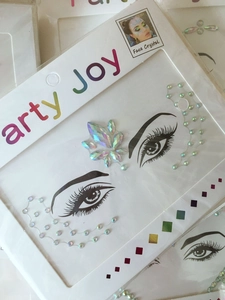 Detailed view of colorful iridescent facial crystals for forehead and eye makeup design