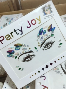 Detailed view of colorful face crystal stickers in teardrop and diamond shapes on card