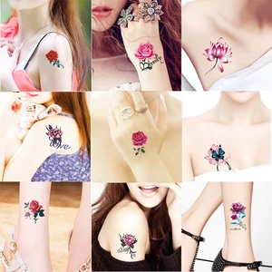 Close-up of waterproof floral tattoo stickers showing roses and butterflies on arm skin