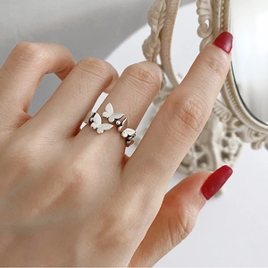 Close-up of S925 sterling silver butterfly bead open ring on female model's finger