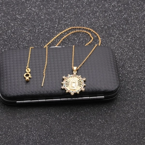 Macro shot of 925 silver stamp on gold plated necklace with Virgin Mary pendant