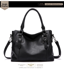 Front view detail of black pebbled leather handbag with silver hardware and dual handles