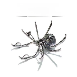 Detailed view of pearl spider brooch with 18K gold plating and non-tarnishing finish