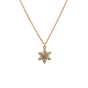 Gold snowflake necklace with micro-paved cubic zirconia crystals on white background