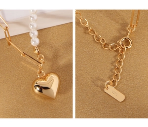 Detail of gold heart pendant with white pearls and S925 engraved lobster clasp