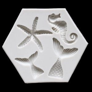 Detail of white silicone mold featuring starfish, seahorse, and mermaid tail cavities