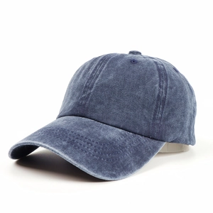 Close-up of deep blue washed denim fabric and six-panel stitching on baseball cap