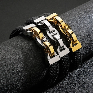 Men's braided leather bracelet set in gold and silver steel finishes on a display