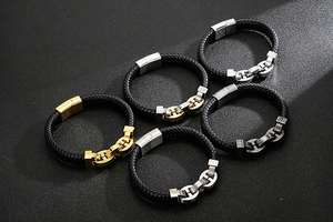 Close-up of woven leather men's bracelets with gold and silver stainless steel clasps