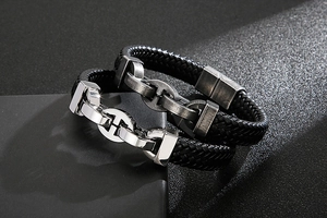 Close-up of double-layered braided black leather bracelet with silver metal anchor clasp