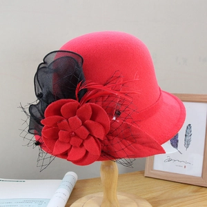 Detail of red wool cloche hat featuring vintage fabric flower and delicate black mesh veil