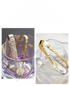 Detail of 304 stainless steel sugar tongs with embossed rose pattern and hanging hook