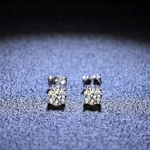 Macro shot of 925 silver four-claw earrings with round brilliant cut moissanite stones