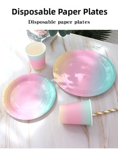 Close-up of pastel rainbow gradient paper plates and cups with gold glitter accents