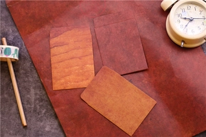 Macro view of vintage brown kraft paper envelopes with natural texture and sewing details