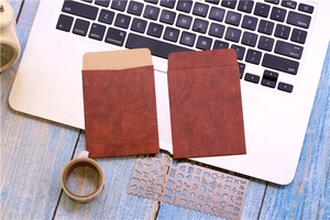Detail of vintage red kraft paper envelopes for cards on an office desk background