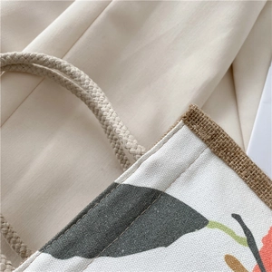 Close-up of woven cotton handles and floral printed canvas on this lunch tote bag
