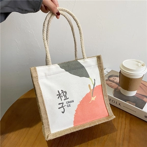 Detail of canvas and jute lunch bag showing orange print and dual-material texture