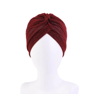 Close-up of wine red metallic turban with glitter texture and twist knot detail
