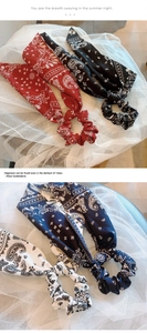 Detail of four paisley pattern chiffon hair scrunchies with long ribbons in four colors