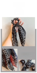 Detail of vintage paisley chiffon scrunchie with soft fabric texture and long ribbon tail