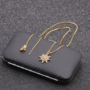 Golden sun pendant necklace with multicolored cubic zirconia on black texture box