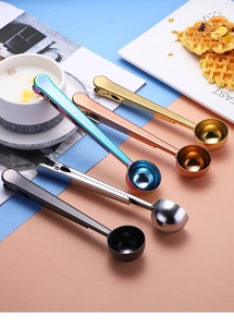 Detailed view of stainless steel coffee measuring spoons with clips in four metallic colors