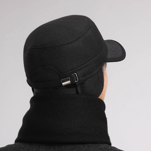 Detail view of winter earflap cap with metal adjustment buckle and warm fabric texture