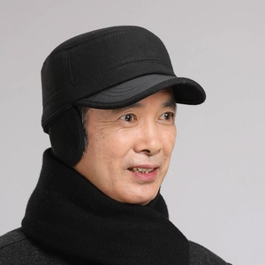 Close-up of black winter flat cap for men with ear protection and matching scarf