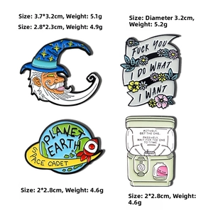 Detail view of cartoon enamel pins featuring moon, rocket, flowers and gashapon designs