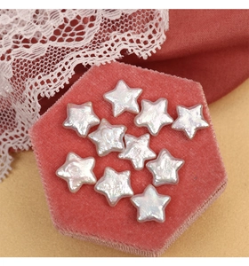 Star-shaped freshwater pearls on a pink velvet jewelry box for DIY crafts