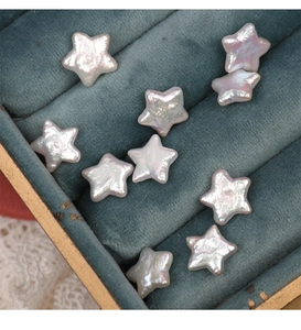 Macro shot of star-shaped freshwater pearls with iridescent luster on velvet