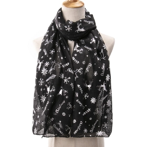Detail of black Christmas scarf with silver reindeer and snowflake foil printing