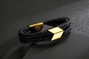 Close-up of men's double-layer black leather bracelet with gold stainless steel arrow clasp