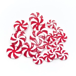 Peppermint swirl candy resin beads for Christmas DIY crafts on white background