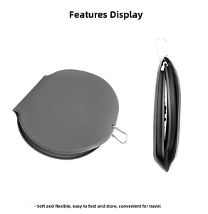 Detail of a dark gray collapsible silicone pet bowl featuring a silver metal carabiner clip