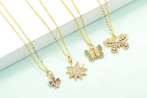 Set of four gold necklaces with colorful zircon clover, star, and butterfly pendants