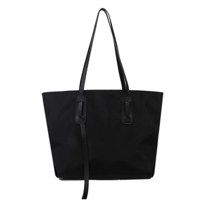 Minimalist black nylon tote bag with large capacity and slim shoulder straps for women