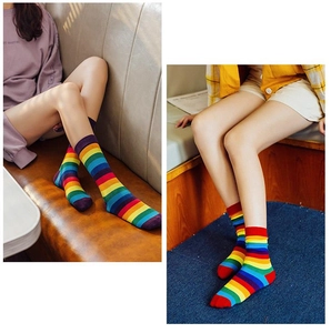 Macro detail of vibrant rainbow striped cotton high socks featuring premium knitted texture